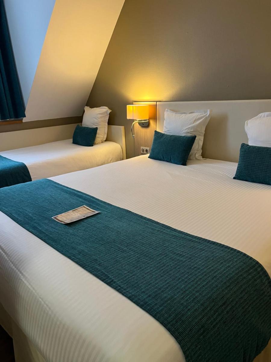 Un ou plusieurs lits dans un hébergement de l'établissement Hotel Normandy