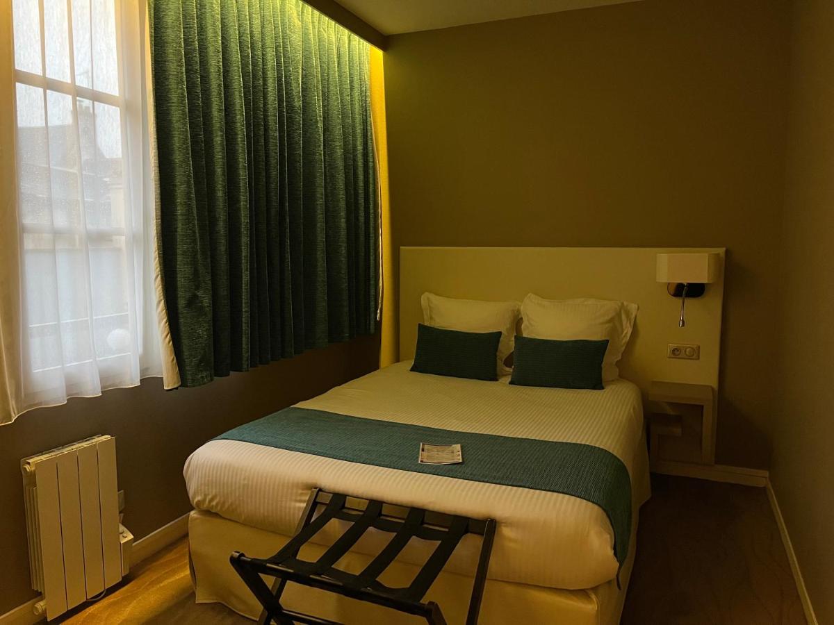 Un ou plusieurs lits dans un hébergement de l'établissement Hotel Normandy