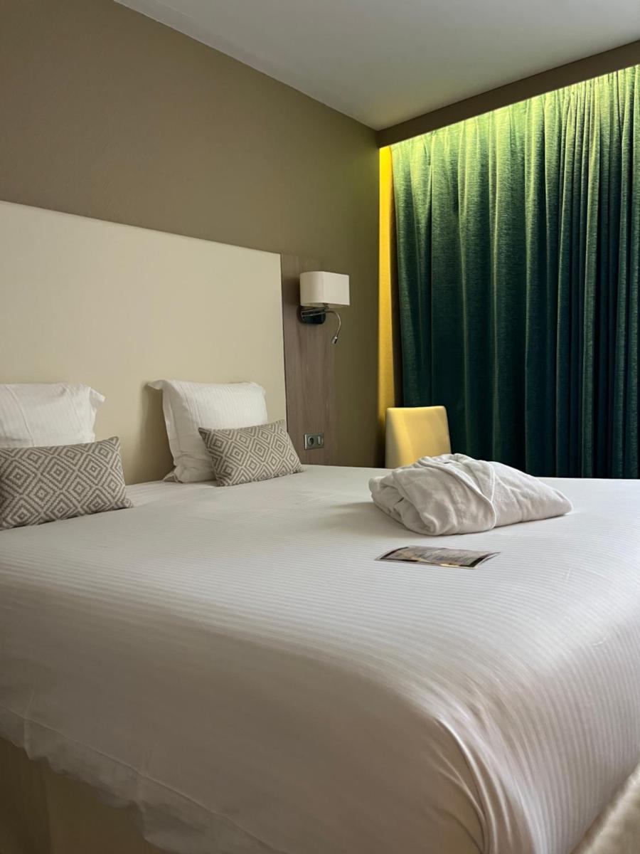 Un ou plusieurs lits dans un hébergement de l'établissement Hotel Normandy