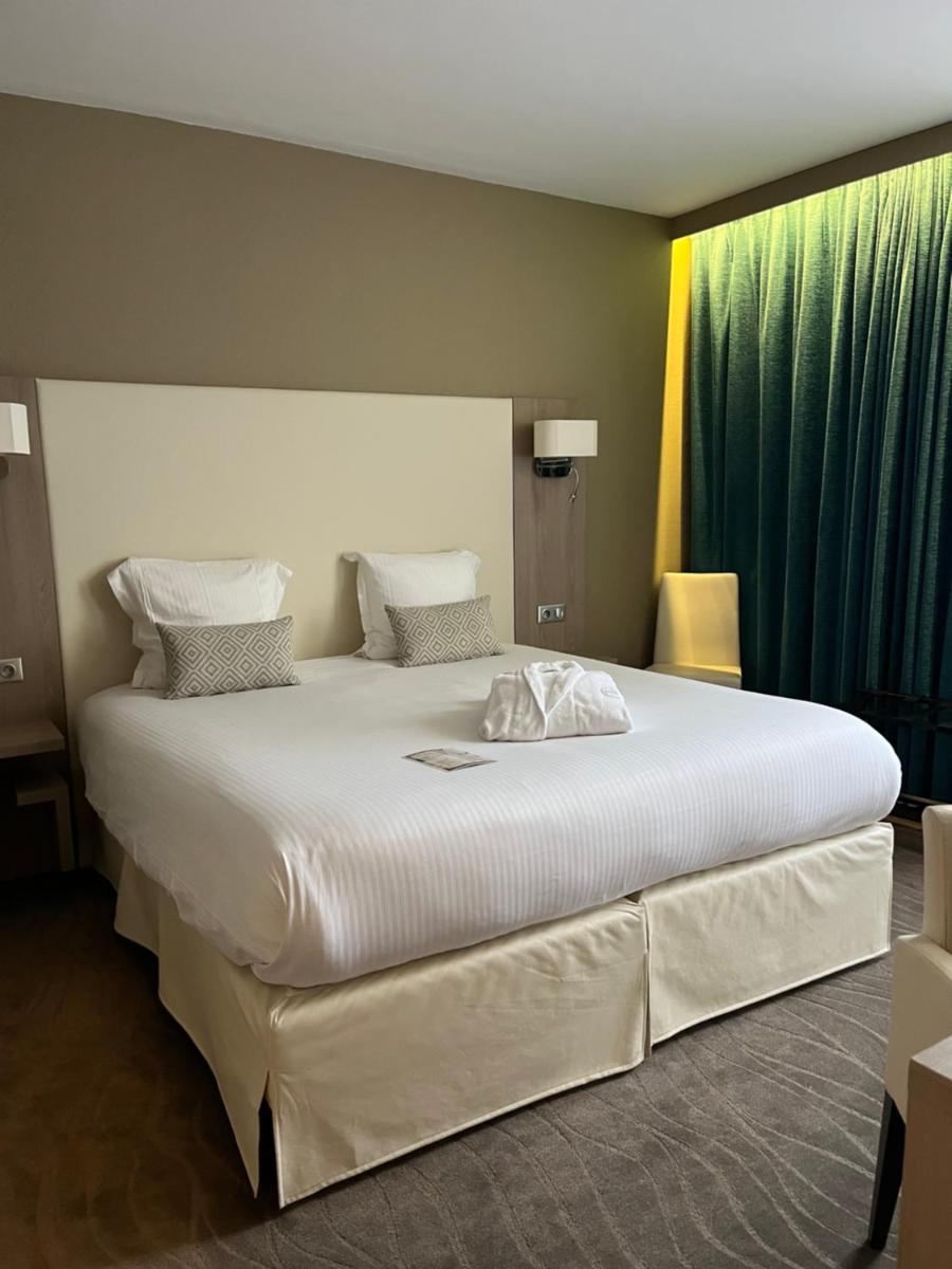 Un ou plusieurs lits dans un hébergement de l'établissement Hotel Normandy