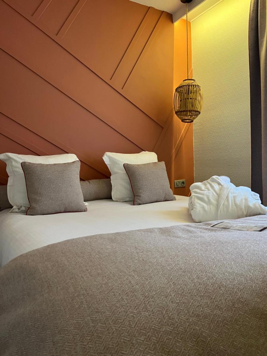 Un ou plusieurs lits dans un hébergement de l'établissement Hotel Normandy