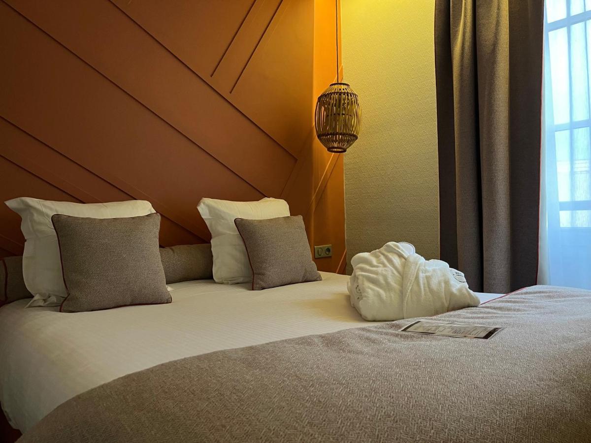 Un ou plusieurs lits dans un hébergement de l'établissement Hotel Normandy