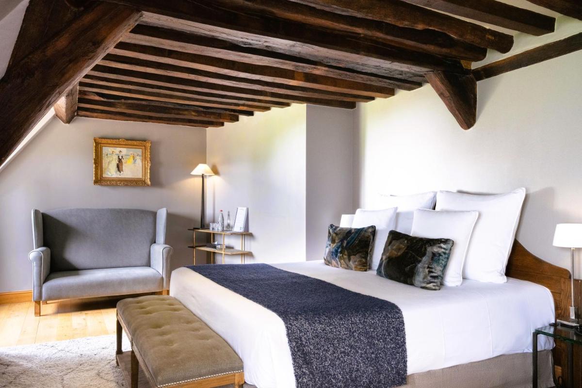 Un ou plusieurs lits dans un hébergement de l'établissement La Ferme Saint Simeon Hotel & Spa - Relais & Chateaux