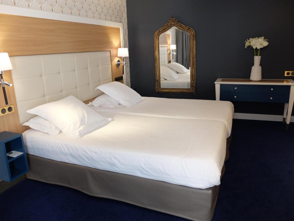 Un ou plusieurs lits dans un hébergement de l'établissement Splendid Hotel & Spa Nice
