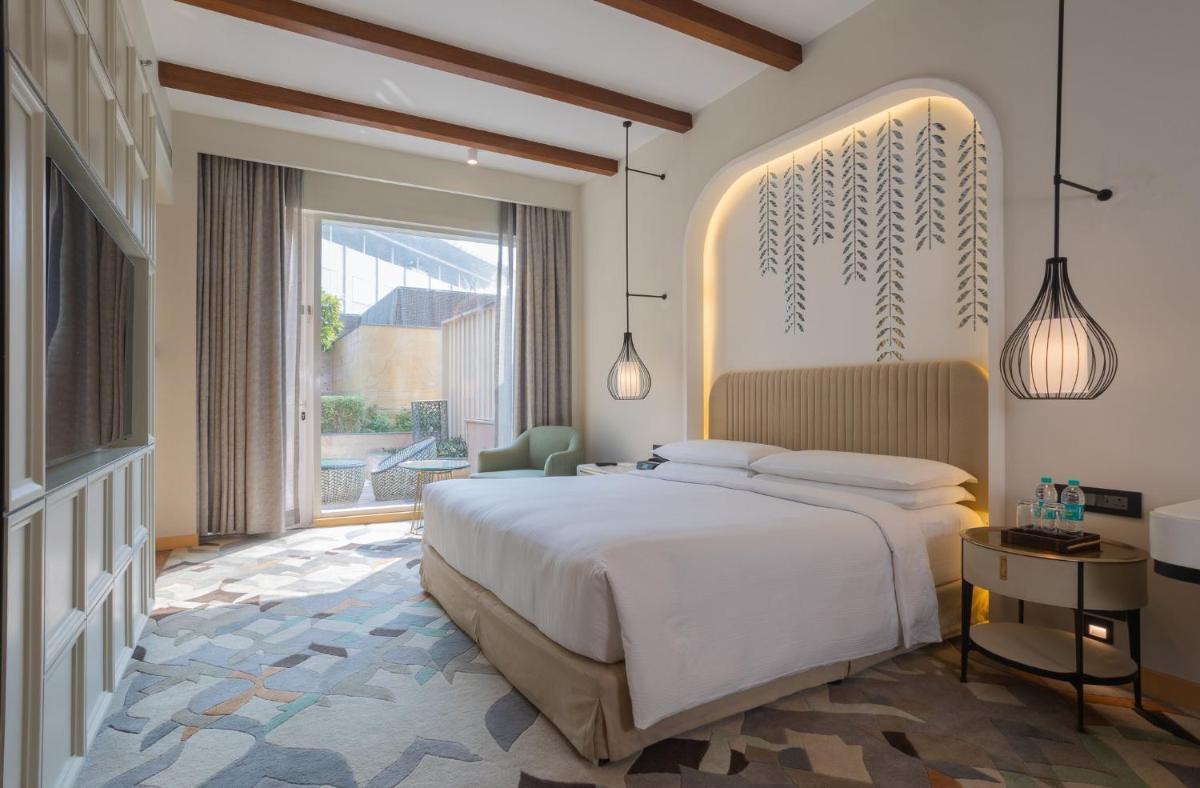 a bedroom with a large bed and a large window at InterContinental Jaipur Tonk Road by IHG in Jaipur