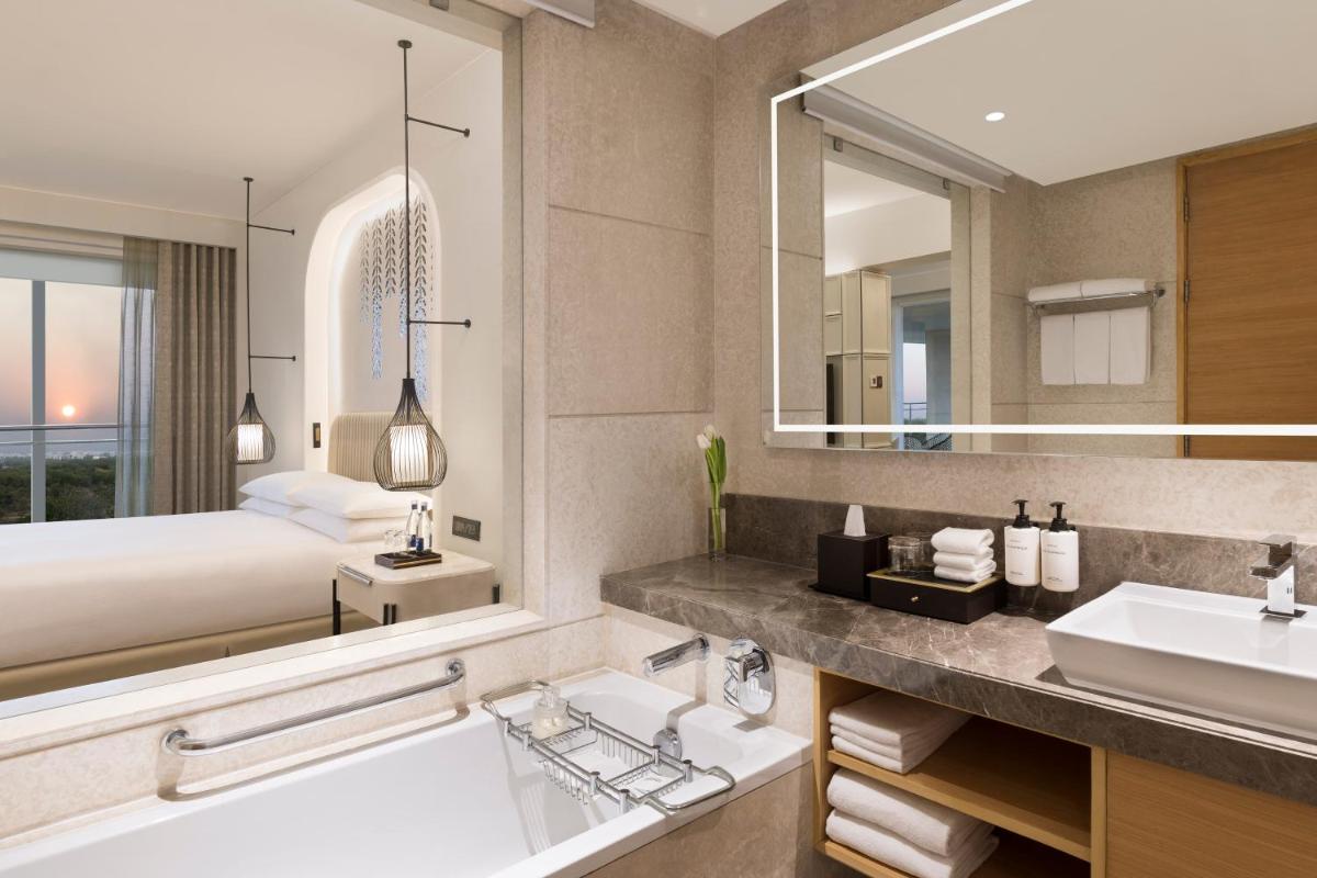 a bathroom with a bed and a sink and a tub at InterContinental Jaipur Tonk Road by IHG in Jaipur