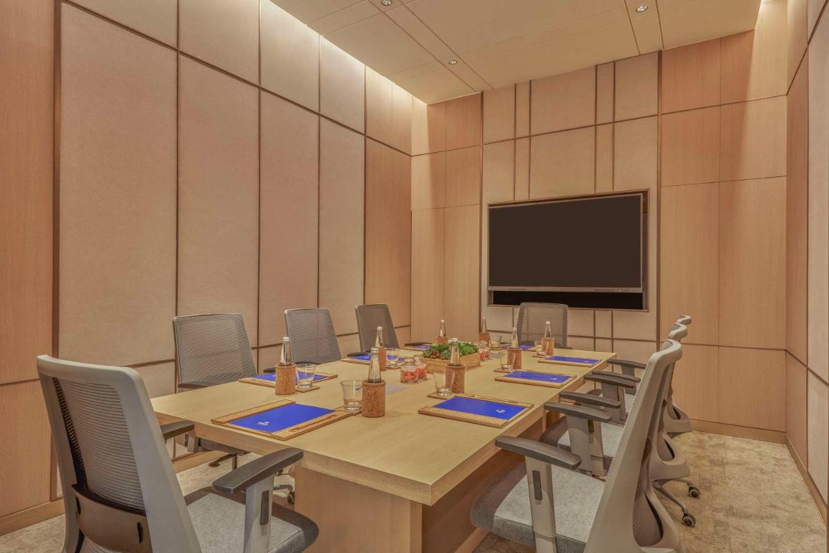 a conference room with a long table and chairs at Hilton Gurugram Baani City Centre in Gurgaon