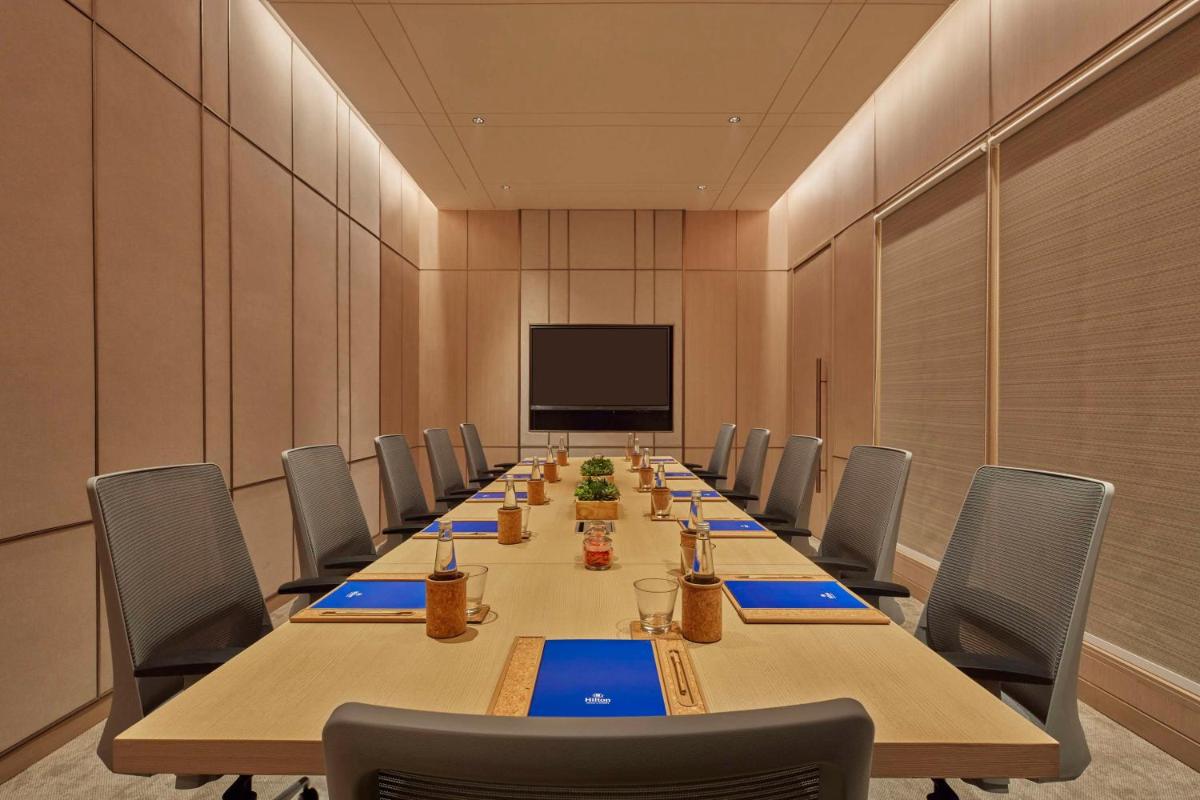 a large conference room with a long table and chairs at Hilton Gurugram Baani City Centre in Gurgaon