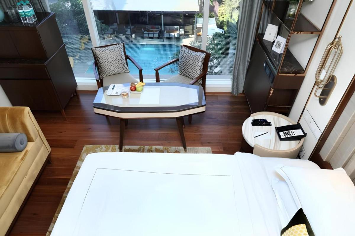 a living room with a couch and a table at Taj MG Road Bengaluru in Bengaluru a living room with a couch and a table at Taj MG Road Bengaluru in Bengaluru