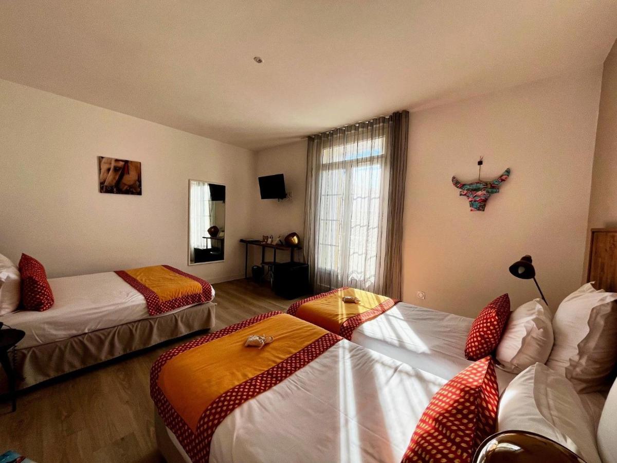 Un ou plusieurs lits dans un hébergement de l'établissement Hôtel Saint Louis