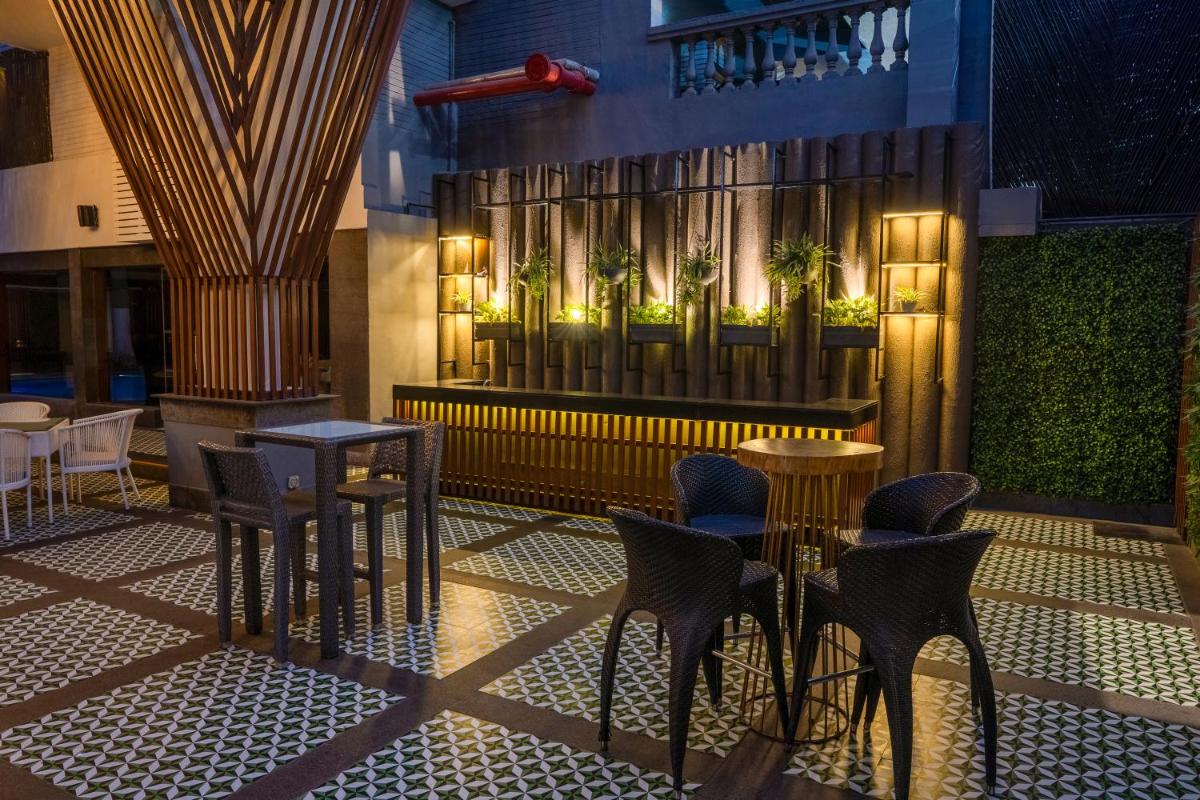 a restaurant with tables and chairs in a building at Park Inn by Radisson,South Delhi in New Delhi a restaurant with tables and chairs in a building at Park Inn by Radisson,South Delhi in New Delhi