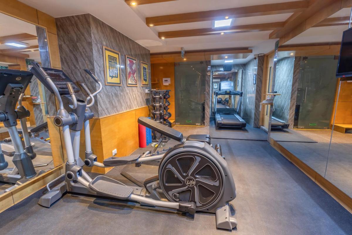 a gym with several tread machines in a room at Park Inn by Radisson,South Delhi in New Delhi a gym with several tread machines in a room at Park Inn by Radisson,South Delhi in New Delhi