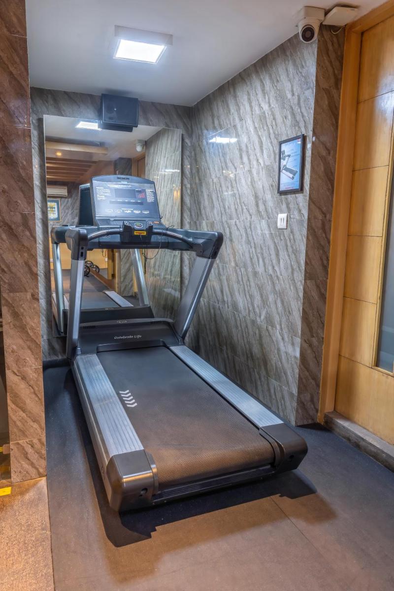 a gym with a treadmill in a room at Park Inn by Radisson,South Delhi in New Delhi a gym with a treadmill in a room at Park Inn by Radisson,South Delhi in New Delhi