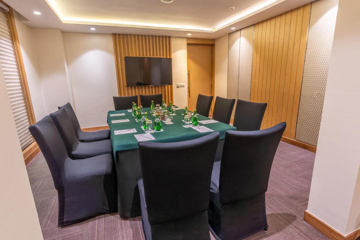 a conference room with a long table and chairs at Park Inn by Radisson,South Delhi in New Delhi a conference room with a long table and chairs at Park Inn by Radisson,South Delhi in New Delhi