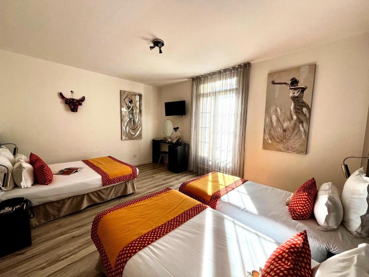 Un ou plusieurs lits dans un hébergement de l'établissement Hôtel Saint Louis