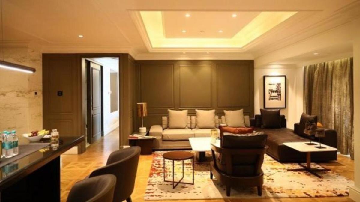 a living room with a couch and a table at Taj MG Road Bengaluru in Bengaluru a living room with a couch and a table at Taj MG Road Bengaluru in Bengaluru