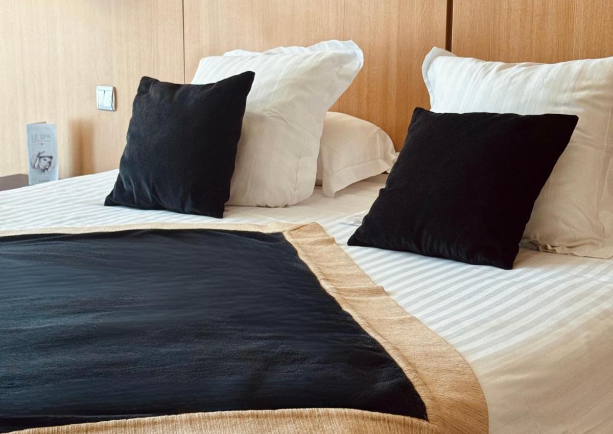 Un ou plusieurs lits dans un hébergement de l'établissement Hotel Spa Le Pasino