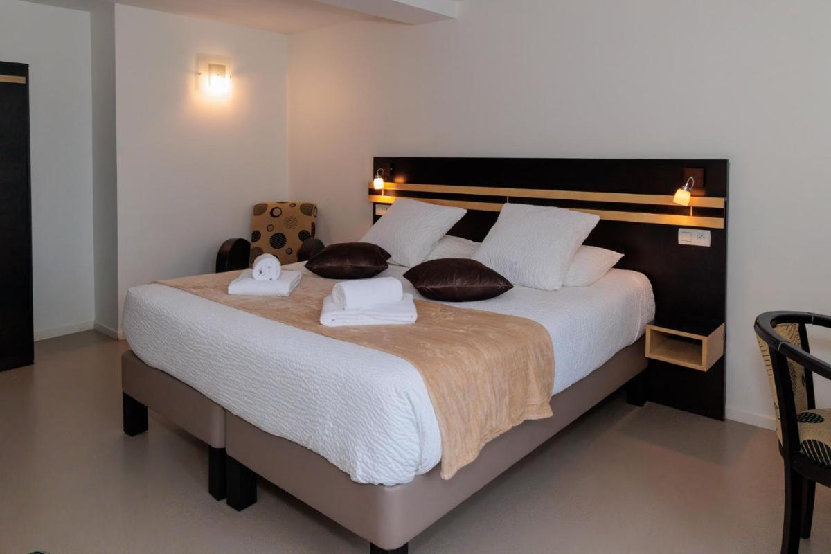 Un ou plusieurs lits dans un hébergement de l'établissement Logis Hôtel Restaurant Auberge de la Xaintrie