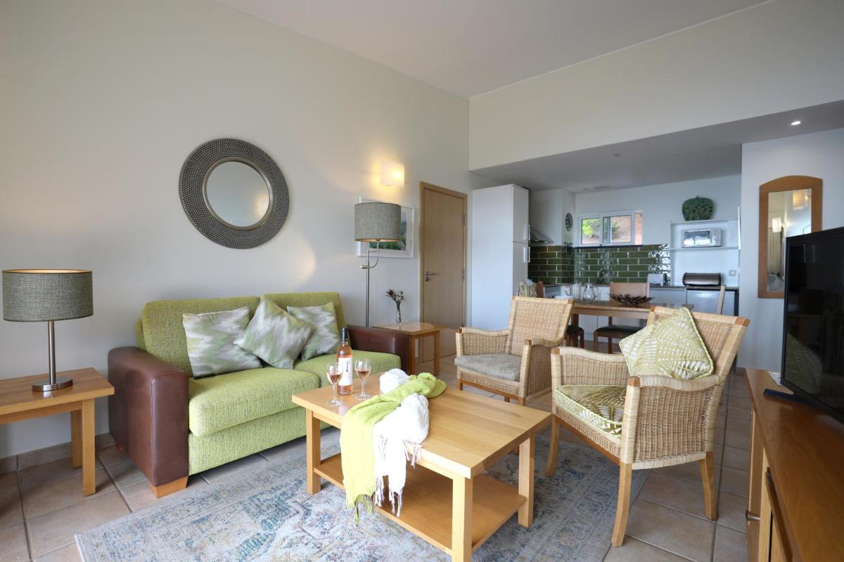 uma sala de estar com um sofá e uma mesa em Village Cabo Girao em Câmara de Lobos