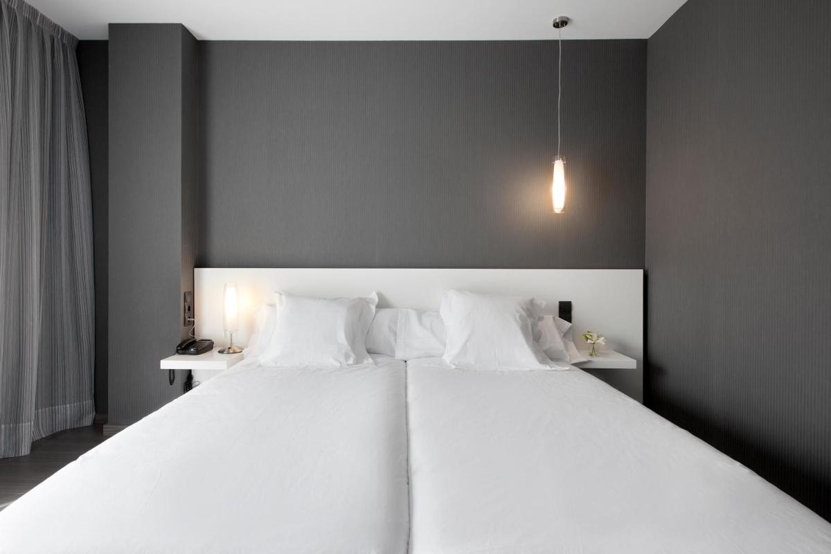Cama o camas de una habitación en Hotel MasMonzon