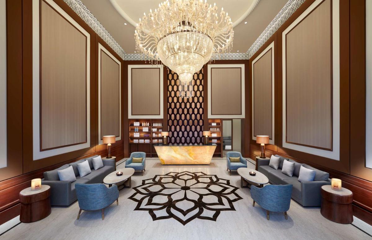 a lobby with blue chairs and a chandelier at Hyatt Regency Jaipur Mansarovar in Jaipur +226 photos a lobby with blue chairs and a chandelier at Hyatt Regency Jaipur Mansarovar in Jaipur +226 photos