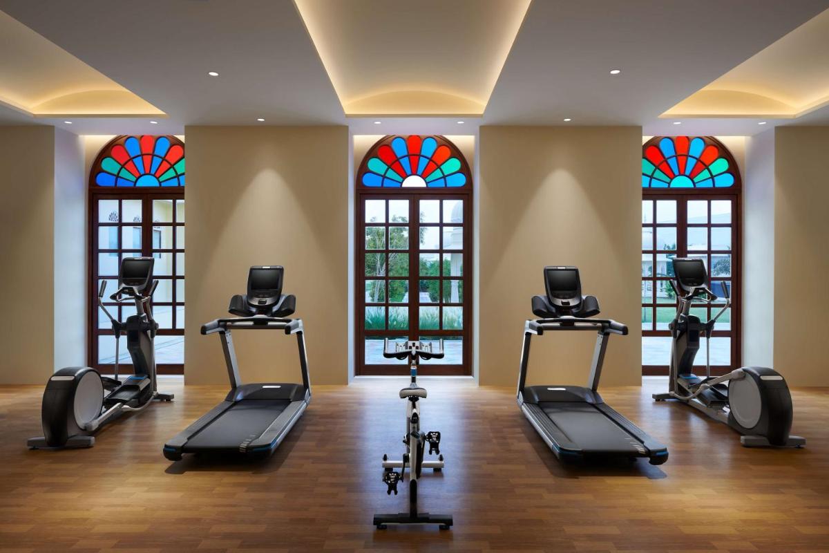 a gym with treadmills and stained glass windows at Hyatt Regency Jaipur Mansarovar in Jaipur a gym with treadmills and stained glass windows at Hyatt Regency Jaipur Mansarovar in Jaipur