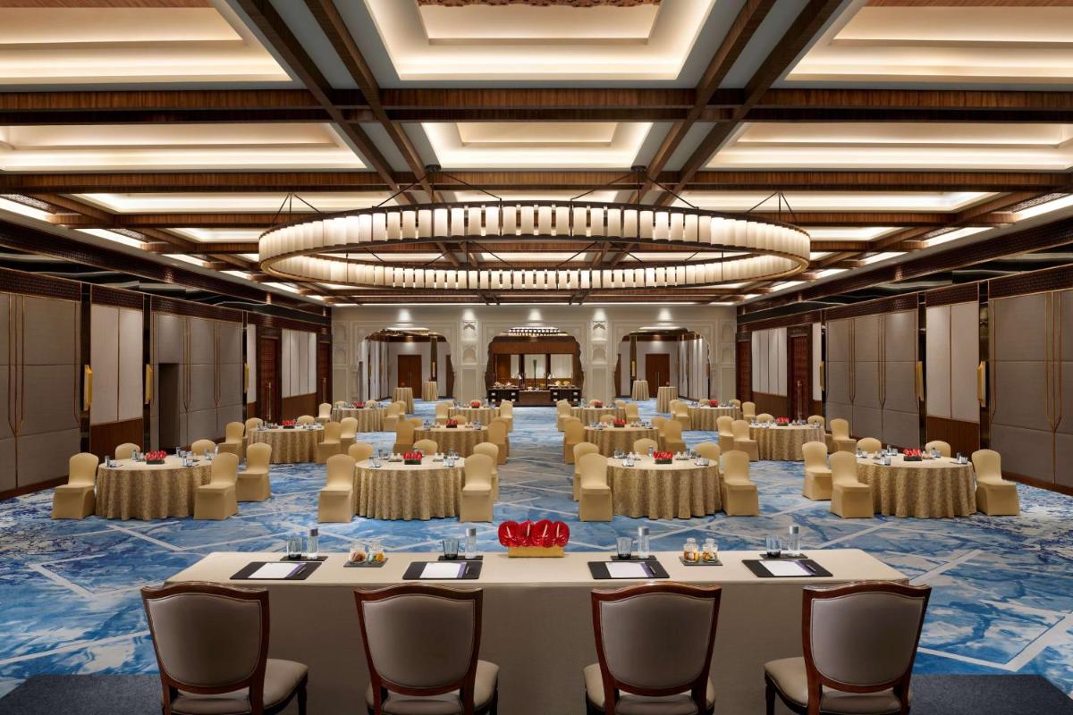 a large room with tables and chairs and a large chandelier at Hyatt Regency Jaipur Mansarovar in Jaipur a large room with tables and chairs and a large chandelier at Hyatt Regency Jaipur Mansarovar in Jaipur