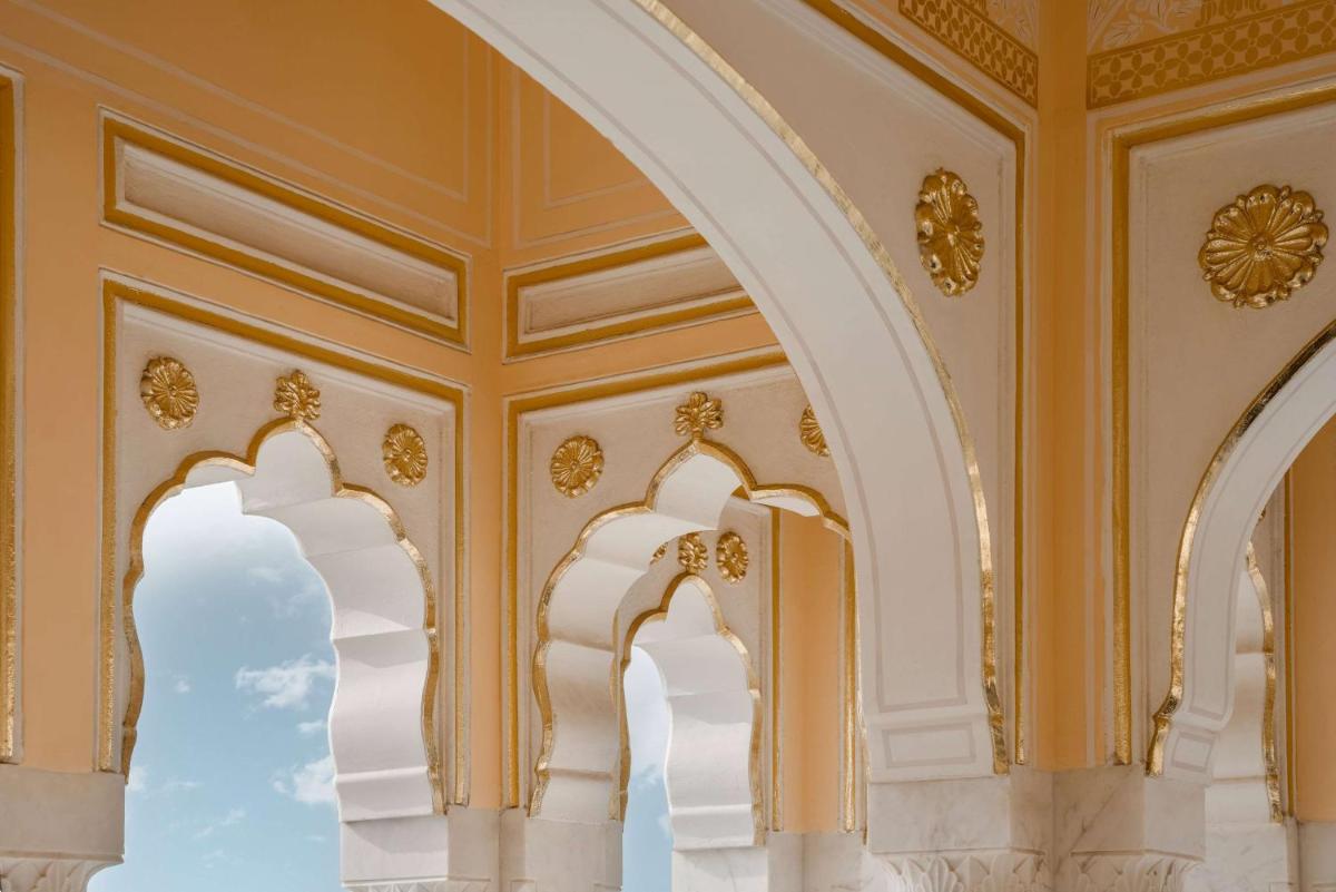 an ornate room with yellow walls and arches at Hyatt Regency Jaipur Mansarovar in Jaipur an ornate room with yellow walls and arches at Hyatt Regency Jaipur Mansarovar in Jaipur
