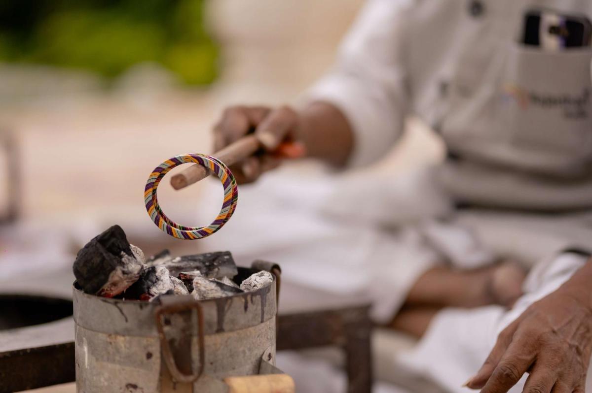 a person putting a ring in a bucket of coal at Hyatt Regency Jaipur Mansarovar in Jaipur a person putting a ring in a bucket of coal at Hyatt Regency Jaipur Mansarovar in Jaipur