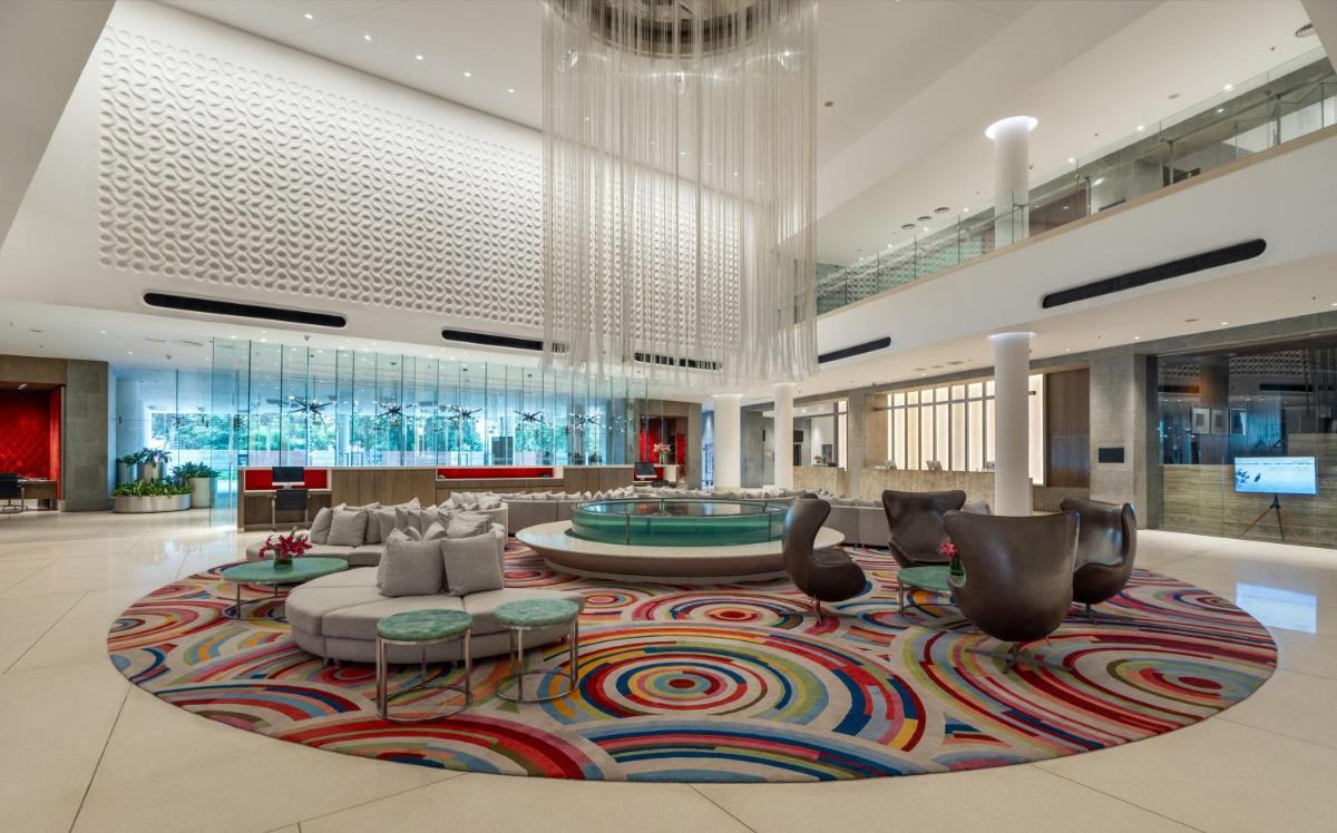 a lobby with a large lobby with a large rug at Avasa Hotel in Hyderabad