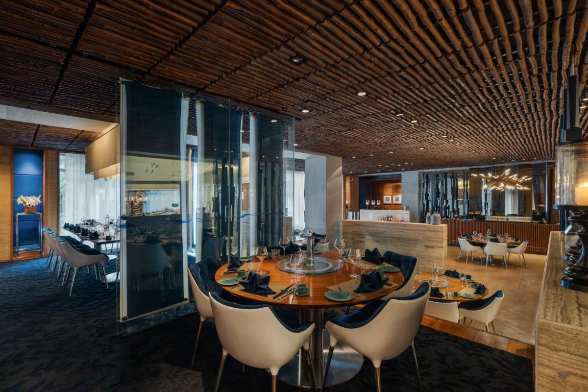 a dining room with a round table and chairs at Avasa Hotel in Hyderabad