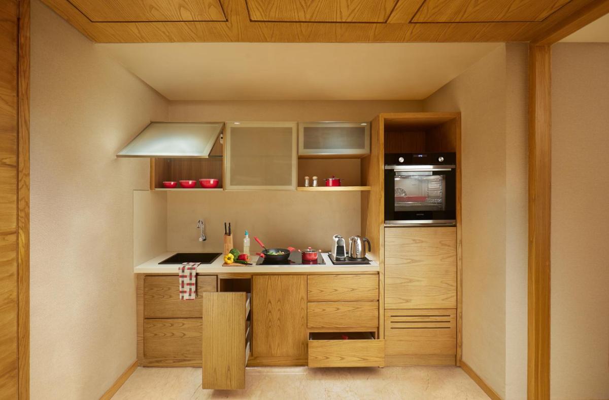 a small kitchen with a sink and a microwave at The Residency Towers in Chennai