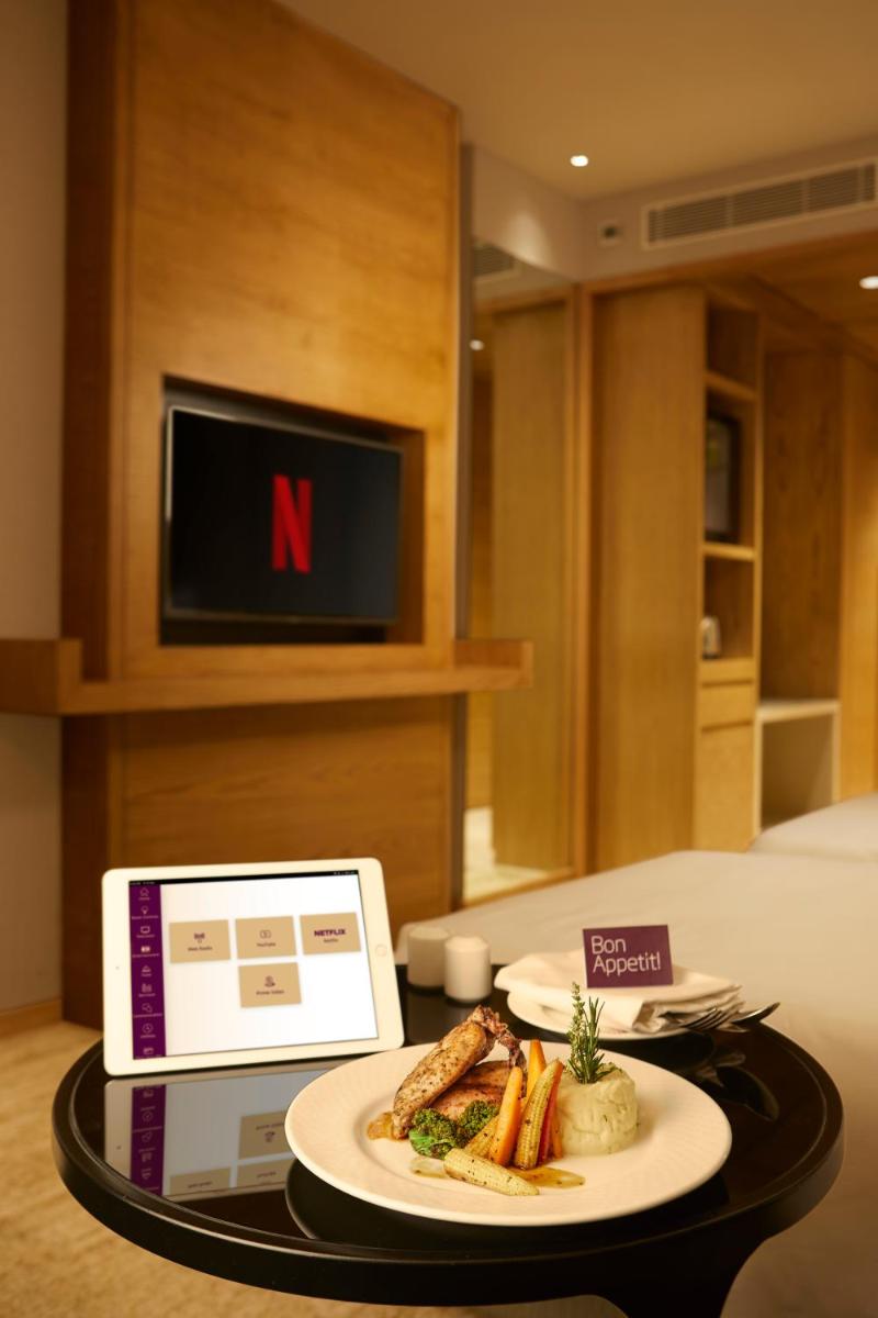 a plate of food on a table in a hotel room at The Residency Towers in Chennai