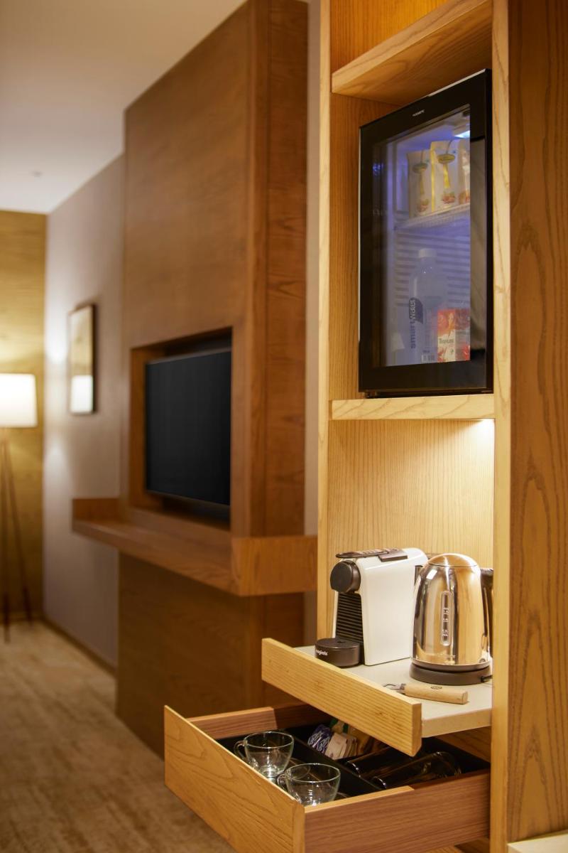 a hotel room with a microwave and a tv at The Residency Towers in Chennai
