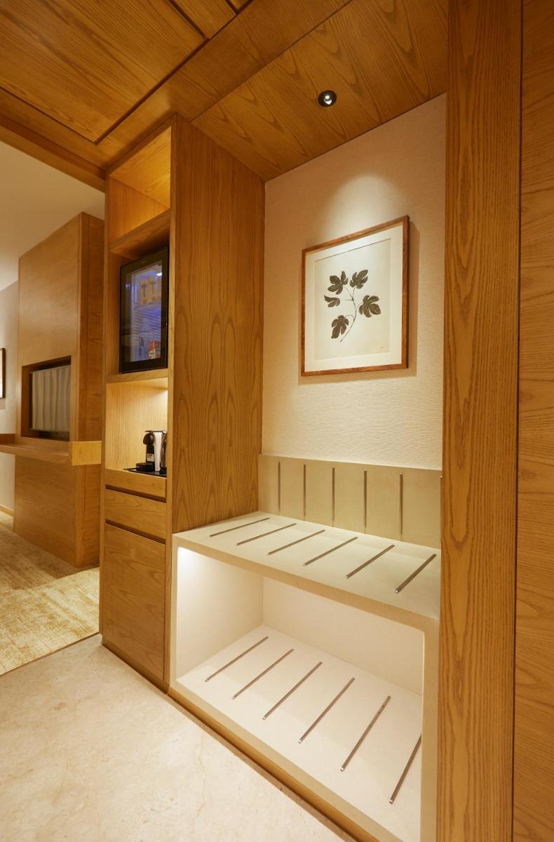 a sauna with white shelves and a wooden ceiling at The Residency Towers in Chennai