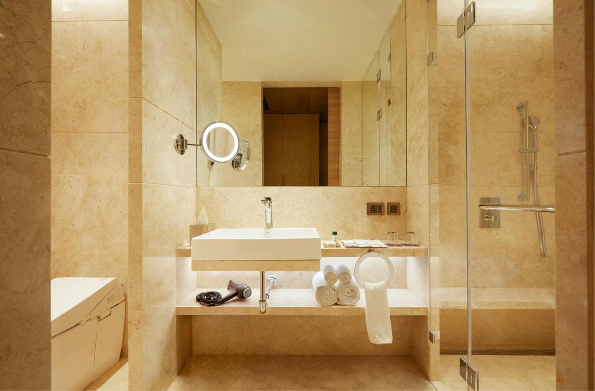 a bathroom with a sink and a shower at The Residency Towers in Chennai