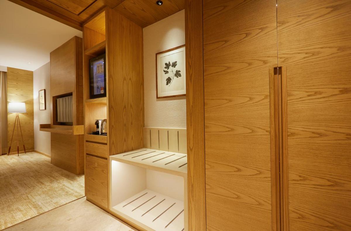 a walk in closet with wooden walls and wooden cabinets at The Residency Towers in Chennai
