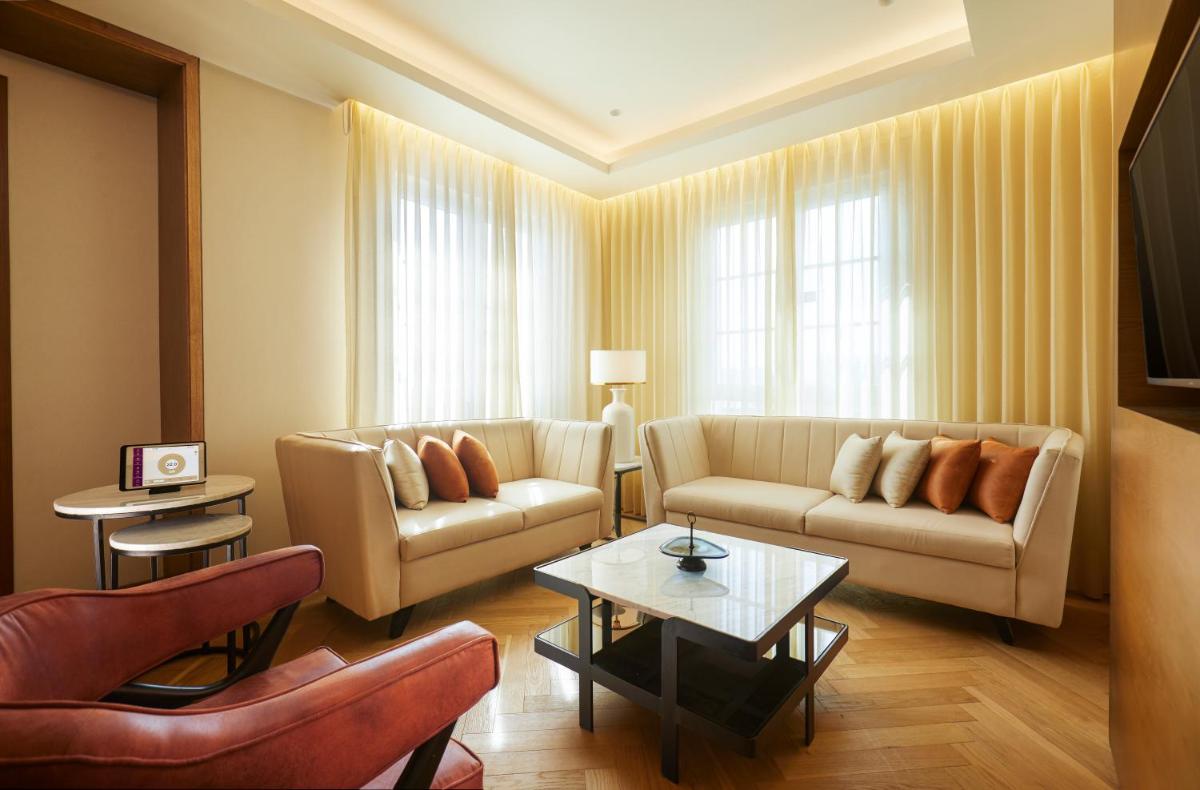 a living room with two couches and a table at The Residency Towers in Chennai