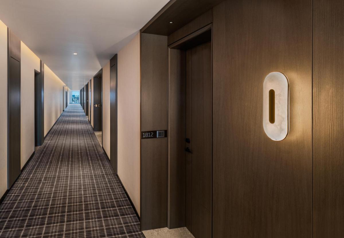 a hallway of a building with a sign on the wall at The Residency Towers in Chennai