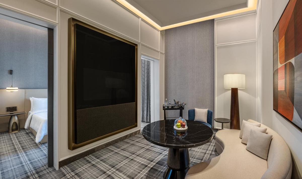 a living room with a large flat screen tv at The Residency Towers in Chennai