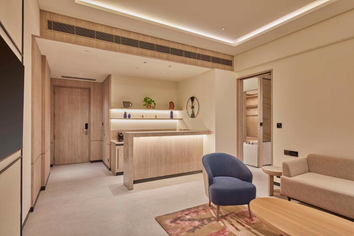 a living room with a couch and a chair at Hilton Gurugram Baani City Centre in Gurgaon