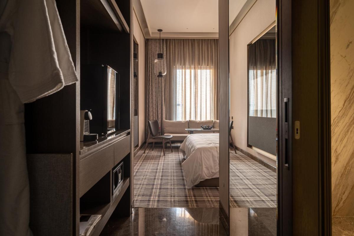 a hotel room with a bed and a television at The Residency Towers in Chennai
