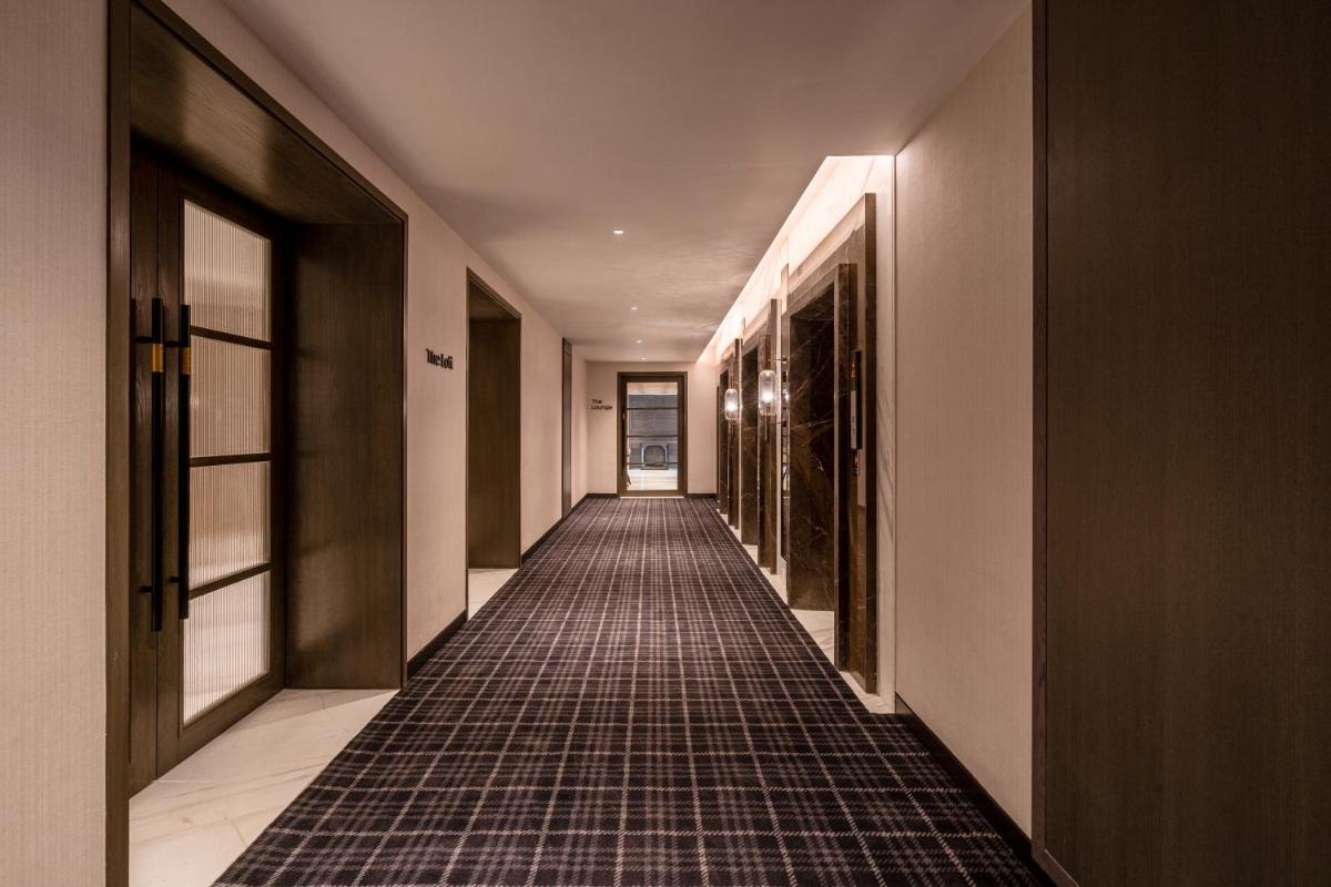 a hallway with a tile floor in a building at The Residency Towers in Chennai