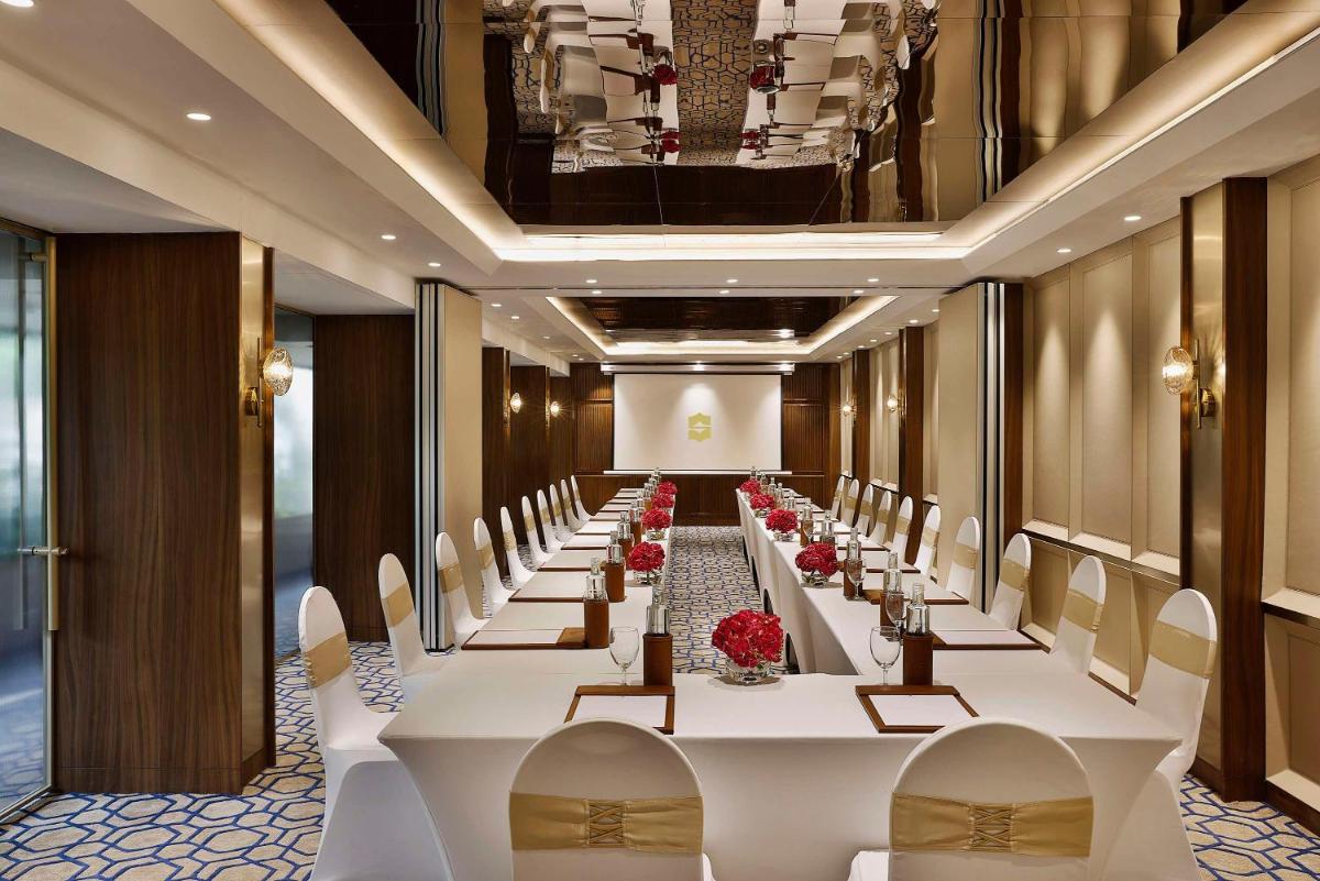 a long banquet hall with white tables and chairs at Shangri-La Eros New Delhi in New Delhi a long banquet hall with white tables and chairs at Shangri-La Eros New Delhi in New Delhi