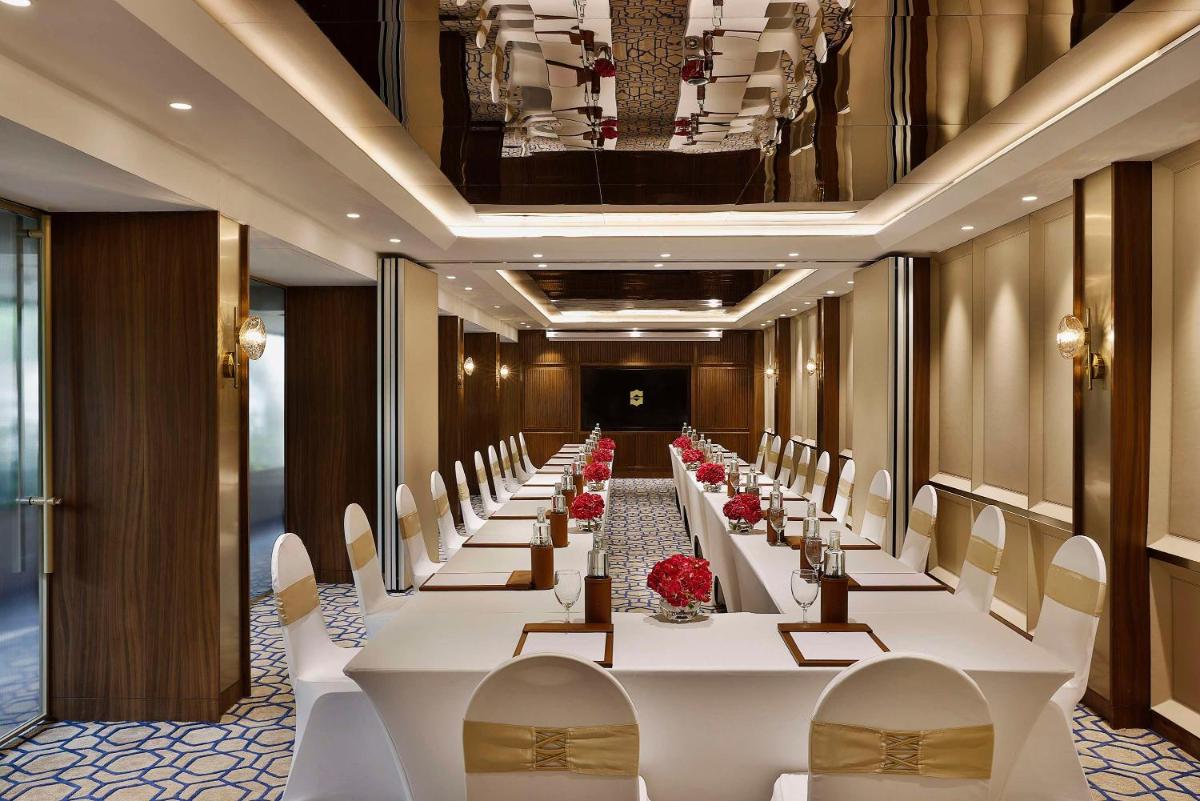 a long banquet hall with white tables and chairs at Shangri-La Eros New Delhi in New Delhi a long banquet hall with white tables and chairs at Shangri-La Eros New Delhi in New Delhi