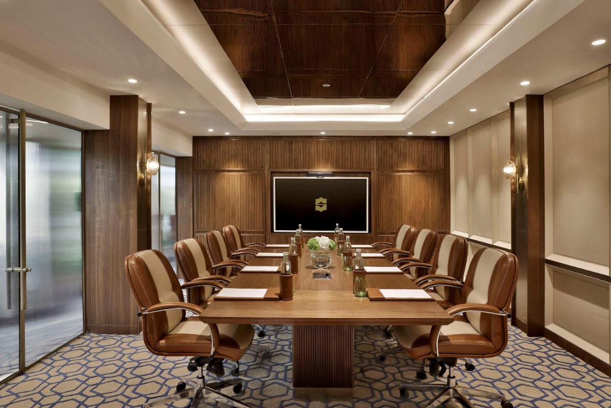 a large conference room with a long table and chairs at Shangri-La Eros New Delhi in New Delhi a large conference room with a long table and chairs at Shangri-La Eros New Delhi in New Delhi