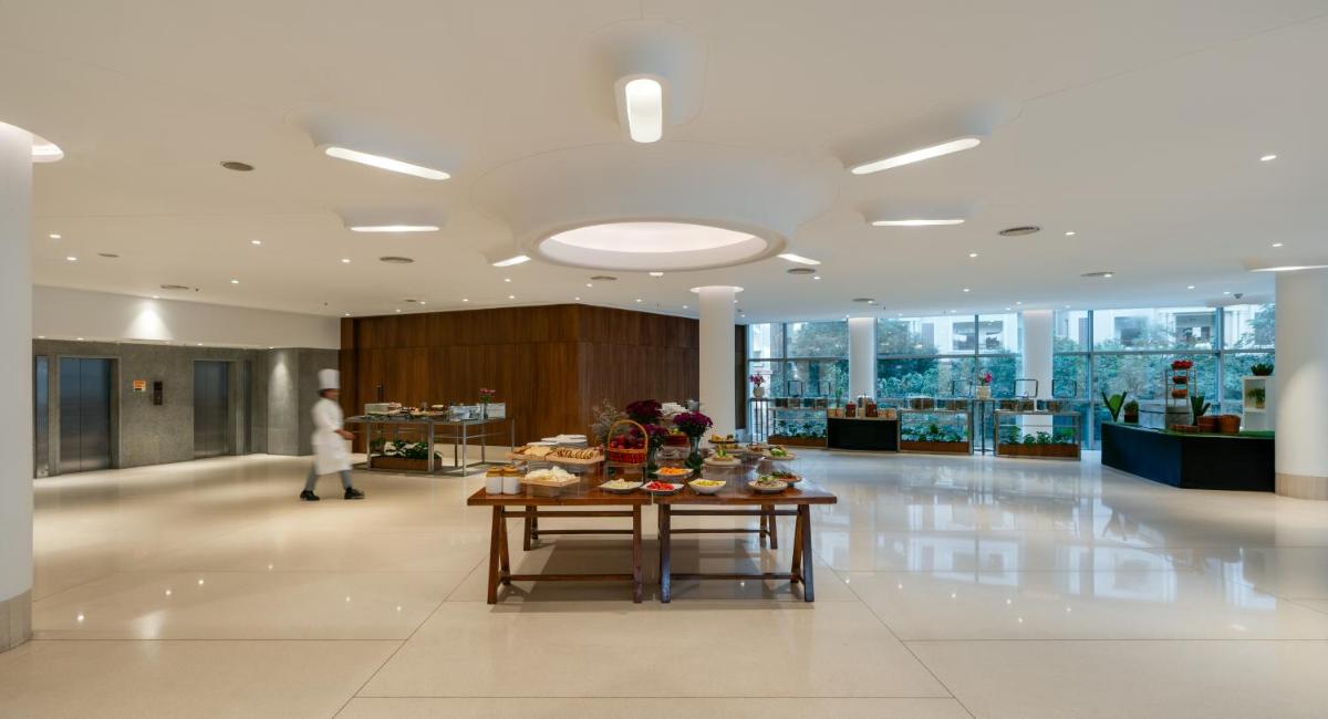 a large lobby with a table with food on it at Avasa Hotel in Hyderabad +31 photos