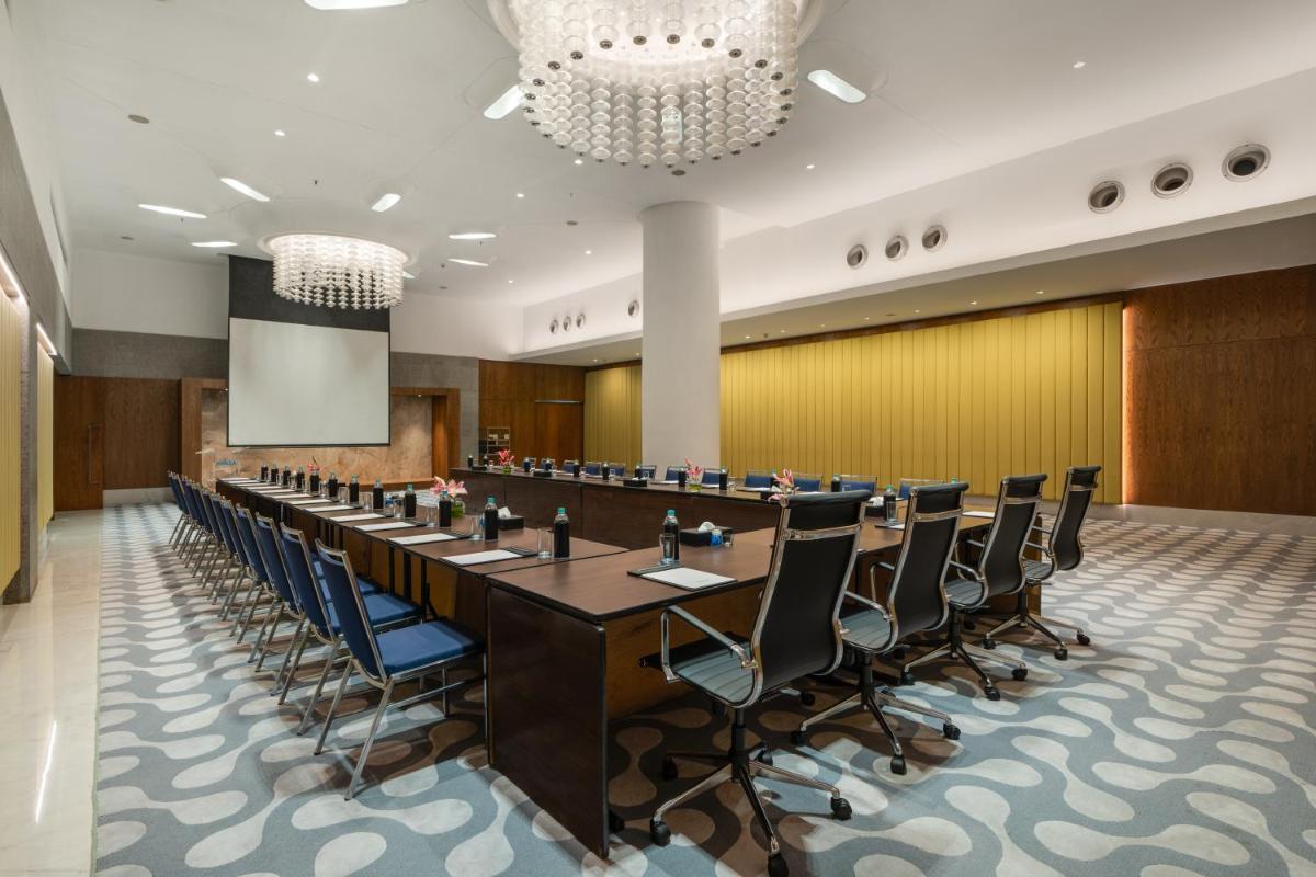 a large conference room with a long table and chairs at Avasa Hotel in Hyderabad