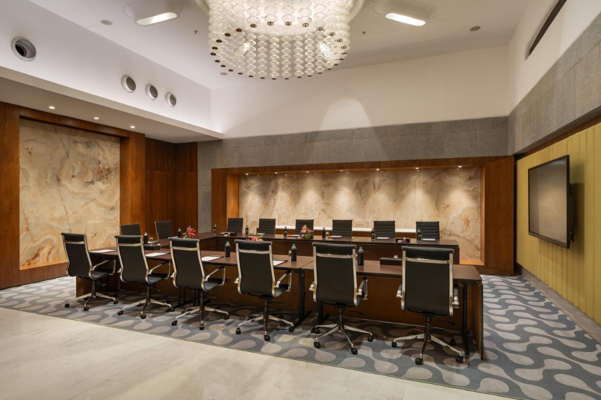 a large conference room with a long table and chairs at Avasa Hotel in Hyderabad