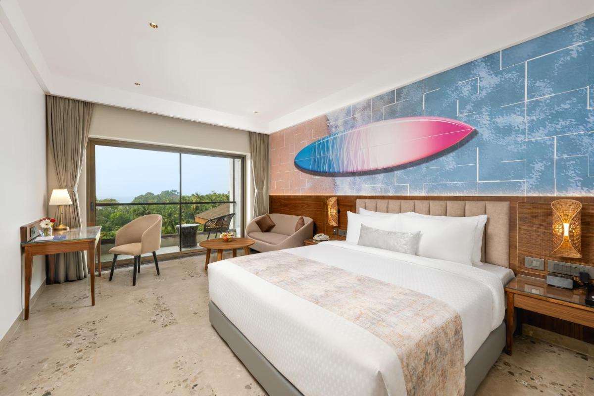 a hotel room with a bed and a large window at Gateway Goa, Palolem in Palolem